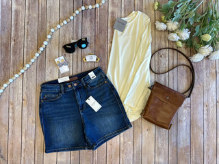 Judy Blue adjustable double button highrise denim shorts styled with yellow top, brown crossbody bag and accessories