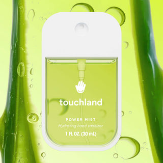 Touchland Power Mist hydrating hand sanitizer bottle surrounded by green aloe vera gel and water droplets