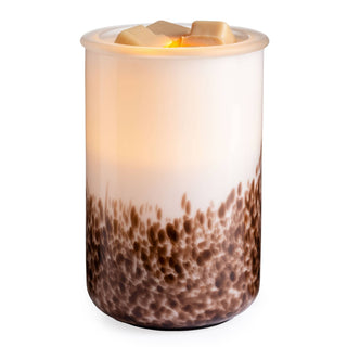 Glass fragrance warmer with textured base design and wax melts on top, illuminated from within