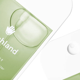 Touchland Applelicious Power Mist Hand Sanitizer in green packaging with transparent pump dispenser closeup.