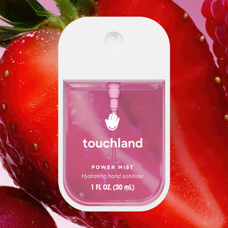 Touchland Power Mist hydrating hand sanitizer in white and pink packaging with strawberry background