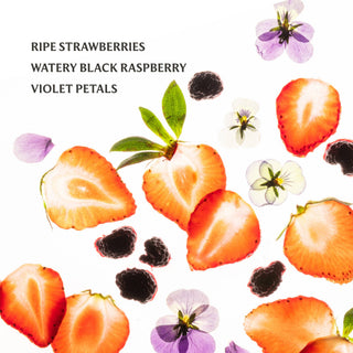 Fresh strawberry slices, blackberries, and violet petals scattered on white background for berry hand sanitizer product.