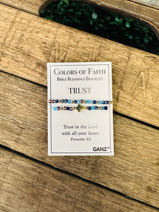 Ganz Colors of Faith Bible Blessings Bracelet with cross charm displayed on rustic wooden surface.