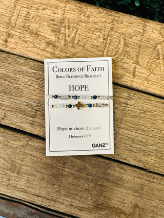 Ganz Colors of Faith Bible Blessings Bracelet set with cross charm displayed on wooden background.