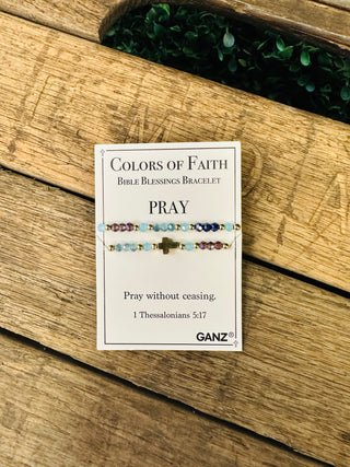 Ganz Colors of Faith Bible Blessings Bracelet with cross charm displayed on rustic wood background.