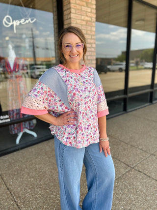 Woman wearing Haptics Blush Floral Fusion Top with mixed fabric panels and flutter sleeves.