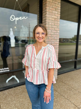 Woman wearing VERY J Boho Striped Blouse with ruffle sleeves and peplum hem, paired with jeans.