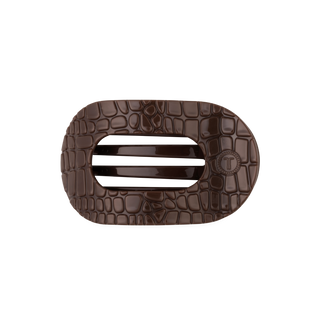TELETIES flat round hair clip with glossy crocodile embossed texture and branded logo detail.