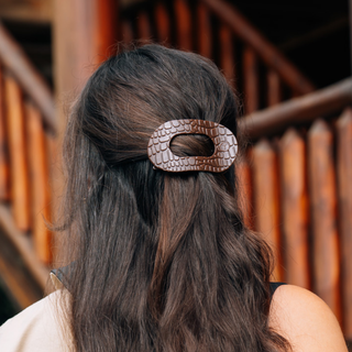 Woman wearing a TELETIES crocodile-textured oval flat hair clip in a half-up hairstyle.