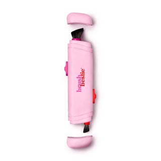 Pink retractable makeup brush with dual-ended brushes and protective caps on white background