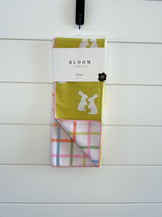 Bloom Towels bunny-themed kitchen dish towel set hanging against white tile wall