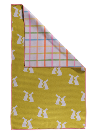 Reversible kitchen towel with white bunny pattern on yellow background and colorful plaid design.