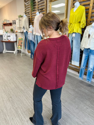 Back view of Blu Pepper textured waffle-knit top with seam detail and cropped fit.