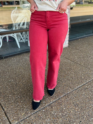 Woman wearing high-rise vintage straight denim jeans paired with a white graphic tee and black flats.