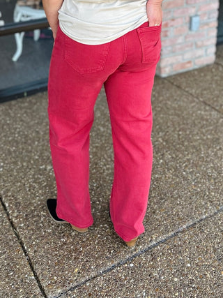 Back view of high-rise vintage straight leg jeans worn with a white tee and boots.