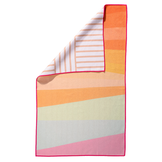 Folded kitchen towel with colorful gradient stripes in sunset hues and striped pattern detail.