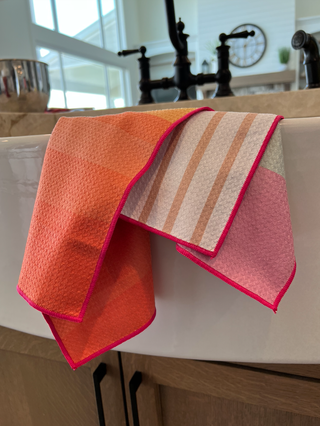 California Sunset Kitchen Towel draped over white cabinet edge in modern kitchen setting