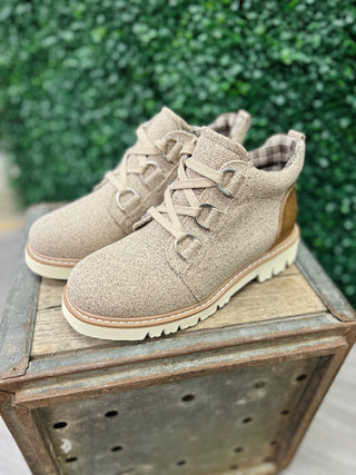 Corkys Campfire Sand Boot lace-up ankle boots displayed on wooden crate with green foliage background