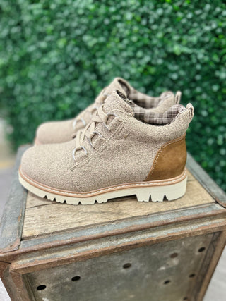 Corkys Campfire Sand Boots in beige canvas with lace-up design on wooden crate outdoors