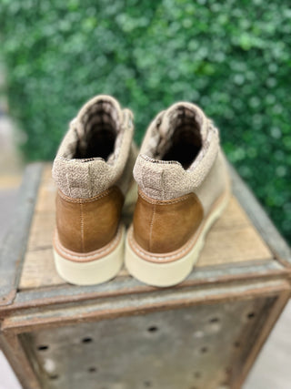 Corkys Campfire Sand Boots with brown suede heel and beige knit collar on wooden crate outdoors