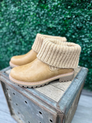 Corkys Caramel Quiver Sweater Boot with knit cuff and rugged sole displayed on wooden crate outdoors
