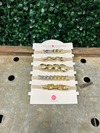 Set of five chain-style hair tie bracelets with metallic accents displayed on white packaging card.