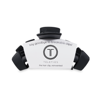 TELETIES hair clips in black displayed around white branded packaging with logo and product messaging.
