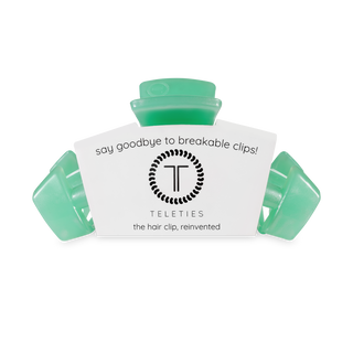 TELETIES hair clips in translucent green packaging with brand logo and tagline about reinvented hair clips