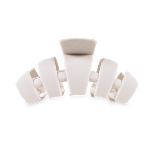White plastic hair clip with interlocking teeth design on transparent background