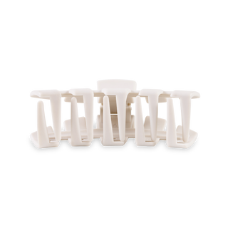 White hair clips arranged in a row showing interlocking tooth design against neutral background