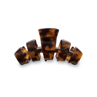 TELETIES Classic Hair Clip in tortoiseshell pattern arranged in curved formation against black background