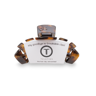 TELETIES hair clip with tortoise shell pattern and white packaging label on black background