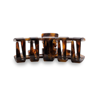 TELETIES classic medium hair clip in tortoise pattern against black background