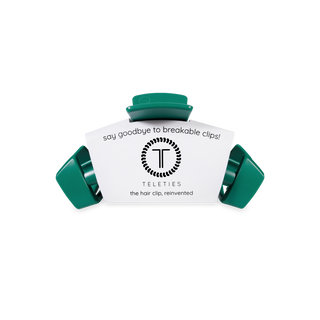 Three green TELETIES hair clips arranged around white product packaging on white background.