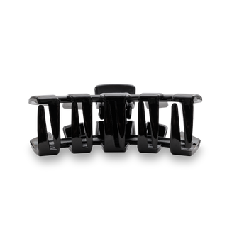 Black hair clip with curved design and multiple grip sections for securing hair
