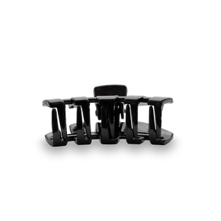 Black hair clip with curved teeth design on transparent background