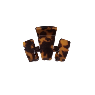 Tortoiseshell patterned hair claw clip with three-pronged design on black background.