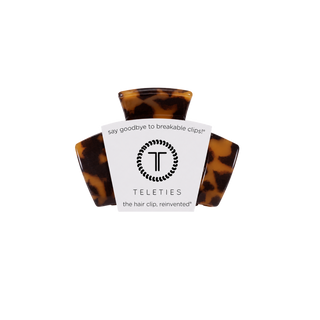 TELETIES claw hair clip in tortoiseshell pattern displayed in packaging on black background.