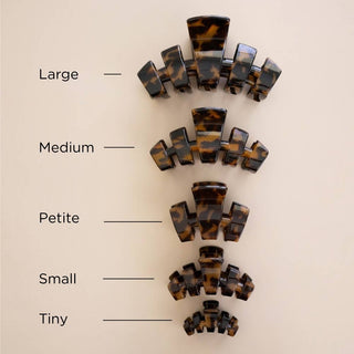 Five tortoiseshell claw clips displayed in descending sizes from large to tiny on neutral background.