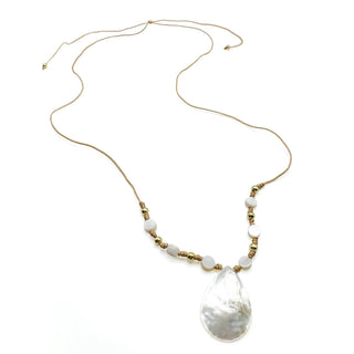 Long gold chain necklace with white beads and large white shell pendant on white background.