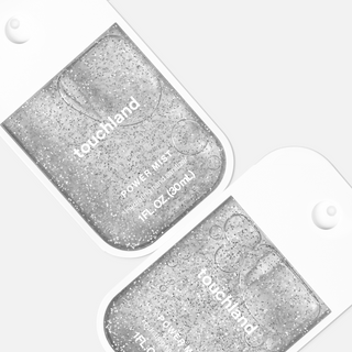 Two Touchland Power Mist hydrating hand sanitizers with glitter-infused formula displayed on white background.