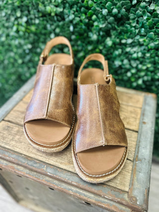 Corkys Volta 2 leather wedge sandals with open toe and slingback strap displayed on rustic wood crate.