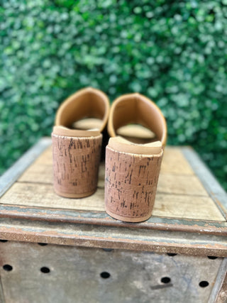 Rear view of Corkys Gaslight cork wedge mules displayed on a rustic wooden crate.