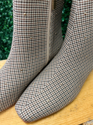 Corky's houndstooth patterned ankle boots with side zipper on wooden surface
