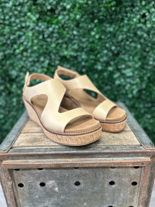 Corky's wedge sandals with cork platform soles displayed on rustic wooden crate outdoors