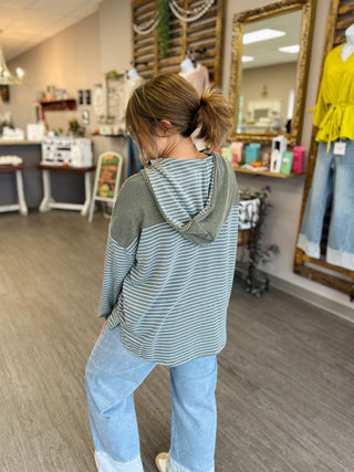 Woman modeling Haptics Cozy & Collected Striped Hoodie Top with wide-leg jeans, back view.