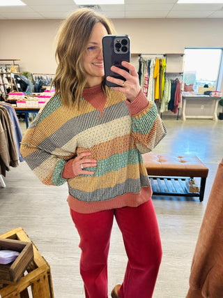 Woman wearing Haptics Cozy & Collected Striped Top with mock neck and ribbed trim in boutique setting.