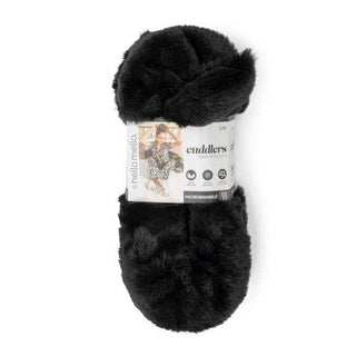 Black fuzzy heated slippers with product label showing comfort features and warming technology