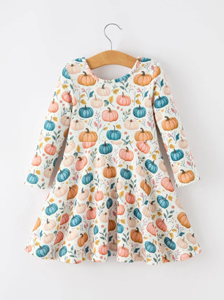 Long-sleeve girls' twirl dress featuring colorful pumpkin and autumn leaf allover print on hanger.