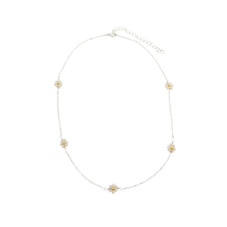 Delicate silver chain necklace featuring five small white daisy flower charms with yellow centers